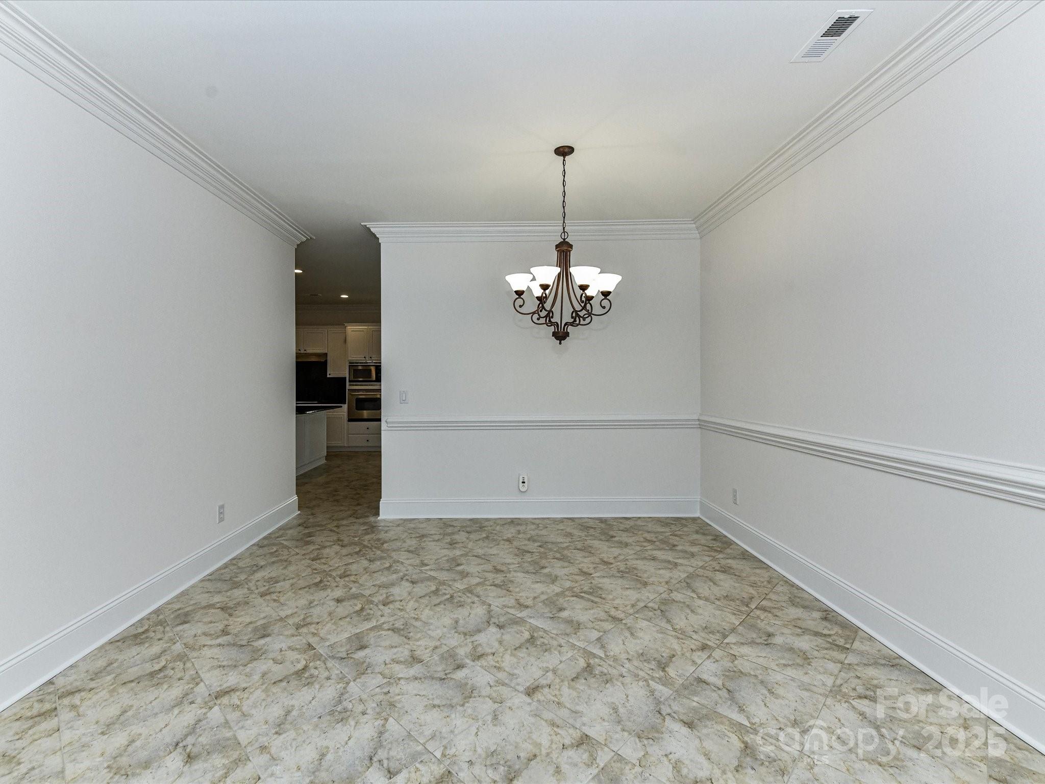 155 Harper Lee Street Davidson, NC 28036 - Photo 7 of 26 a view of a room with a chandelier fan and wooden floor