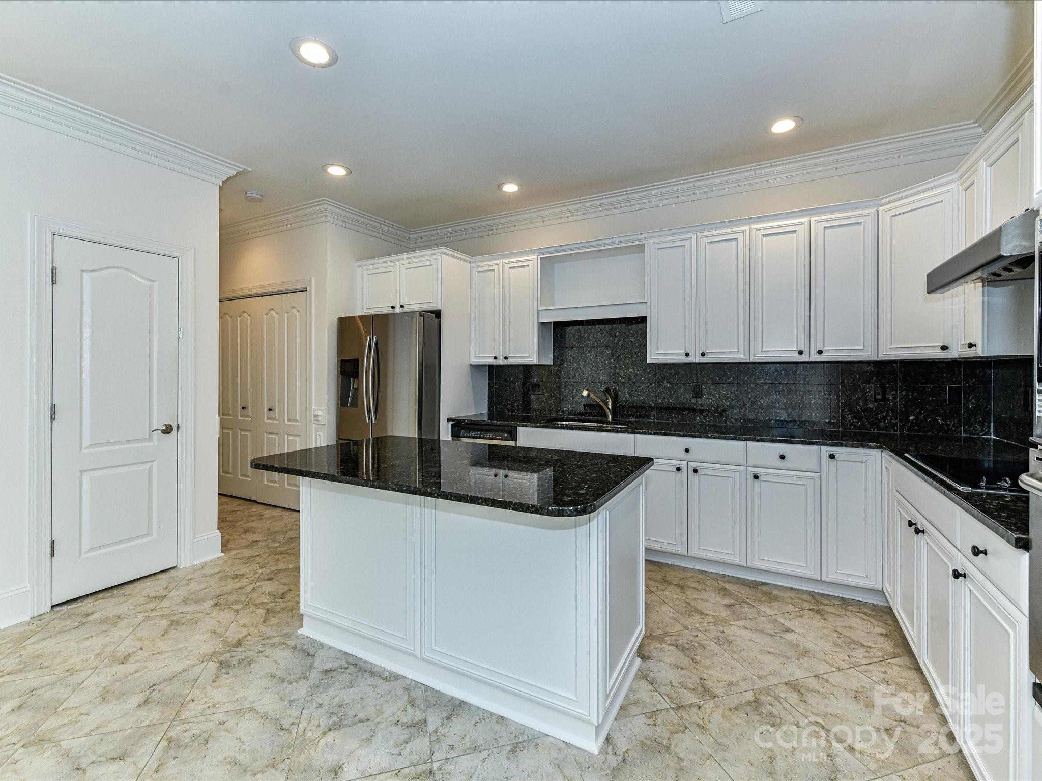 155 Harper Lee Street Davidson, NC 28036 - Photo 9 of 26 a view of a kitchen with stainless steel appliances granite countertop a stove a sink and a refrigerator