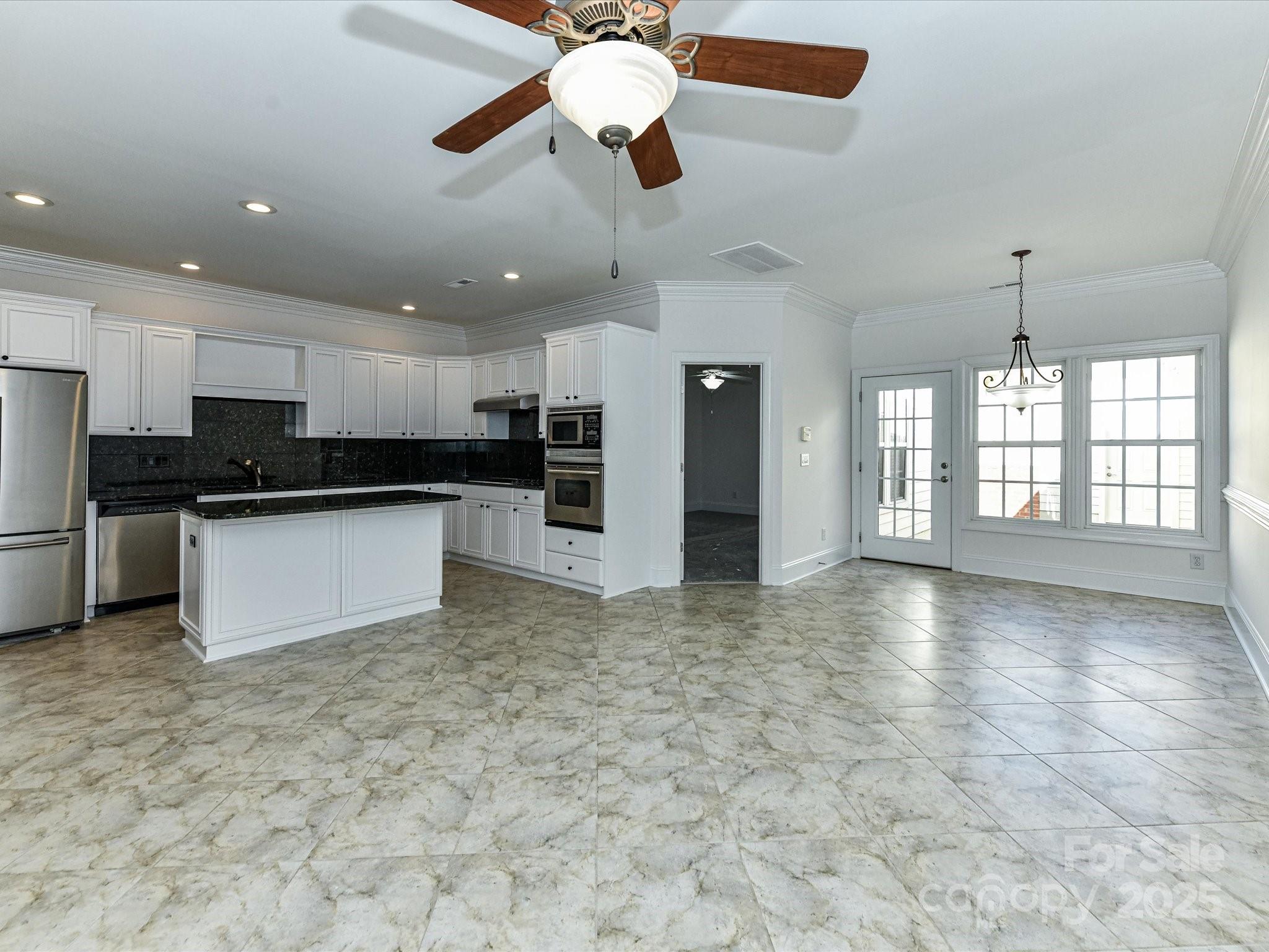 155 Harper Lee Street Davidson, NC 28036 - Photo 10 of 26 a view of a kitchen with a stove and a refrigerator