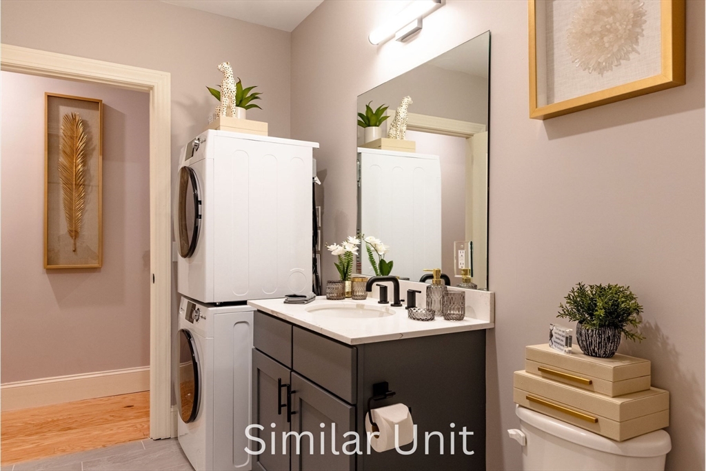 302 Canal Street, Unit 707 Lawrence, MA 01840 - Photo 12 of 12 a bathroom with a sink and a mirror