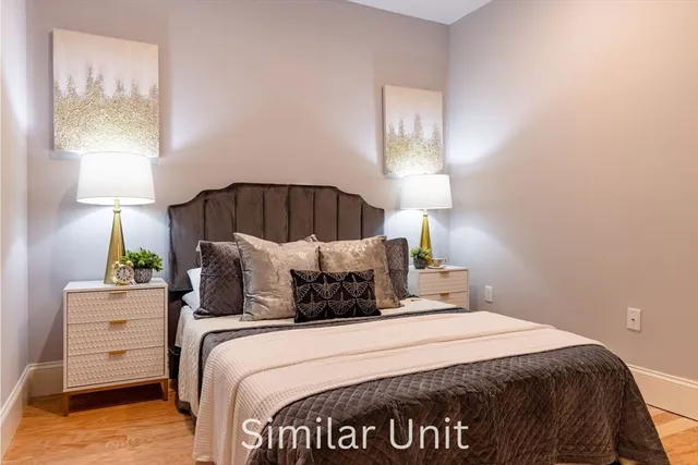 a bedroom with a bed and a night stand