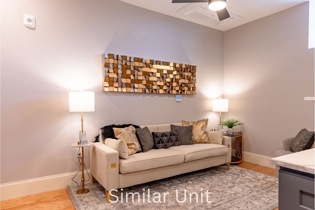 302 Canal Street, Unit 707 Lawrence, MA 01840 - Photo 7 of 12 a living room with furniture and a couch