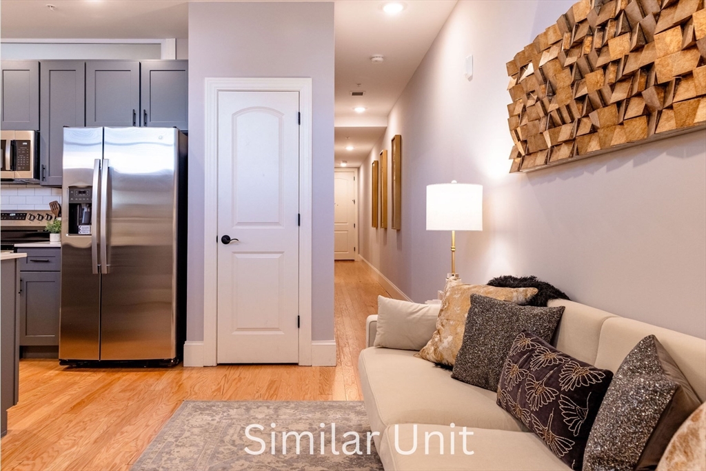 302 Canal Street, Unit 707 Lawrence, MA 01840 - Photo 10 of 12 a bed room with a bed and a mirror