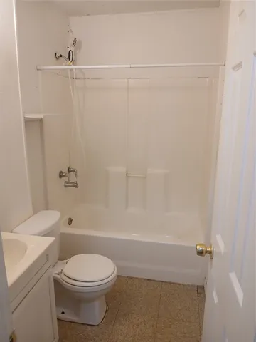 a bathroom with a toilet and shower