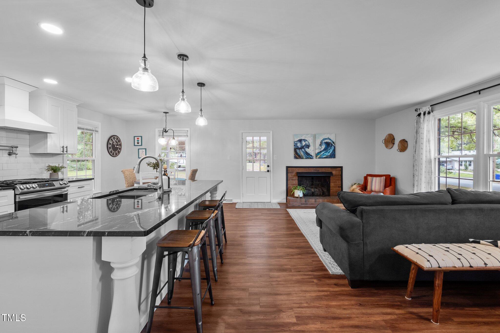 1205 Willow Drive Chapel Hill, NC 27517 - Photo 10 of 45 a large kitchen with cabinets a sink a counter space and stainless steel appliances