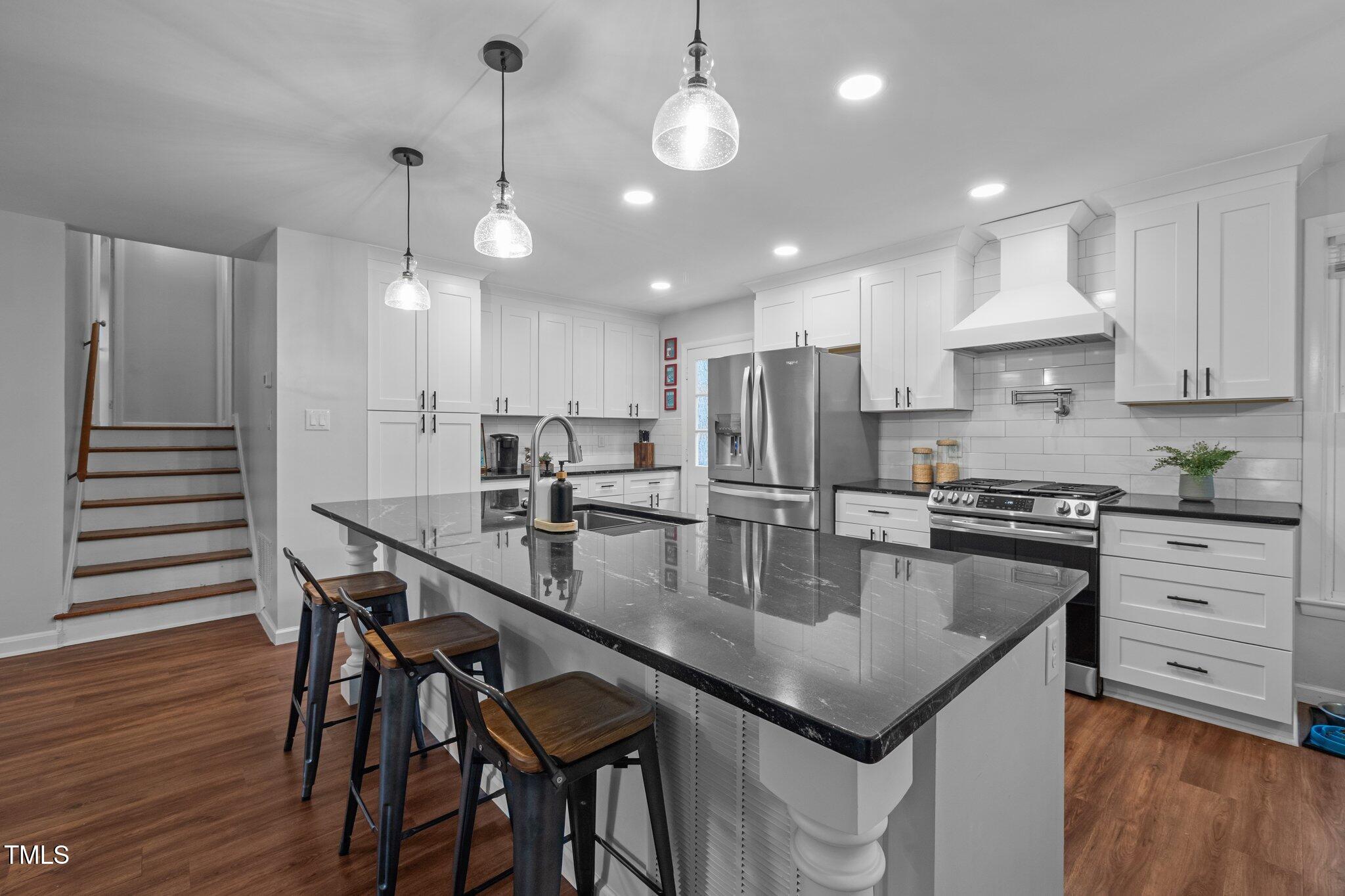 1205 Willow Drive Chapel Hill, NC 27517 - Photo 13 of 45 a kitchen with stainless steel appliances granite countertop a kitchen island a stove a table and chairs
