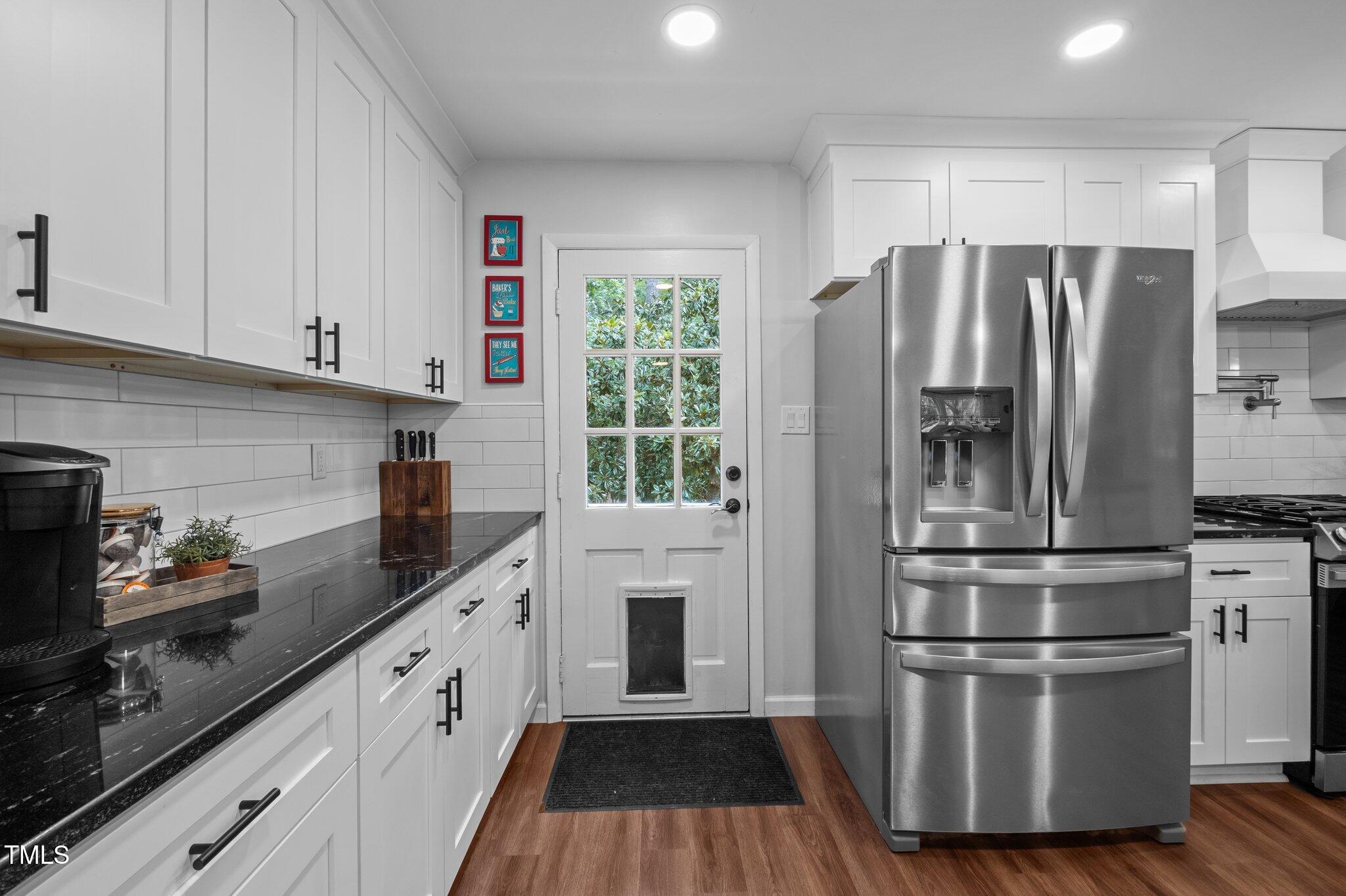 1205 Willow Drive Chapel Hill, NC 27517 - Photo 14 of 45 a kitchen with granite countertop stainless steel appliances a refrigerator sink and cabinets