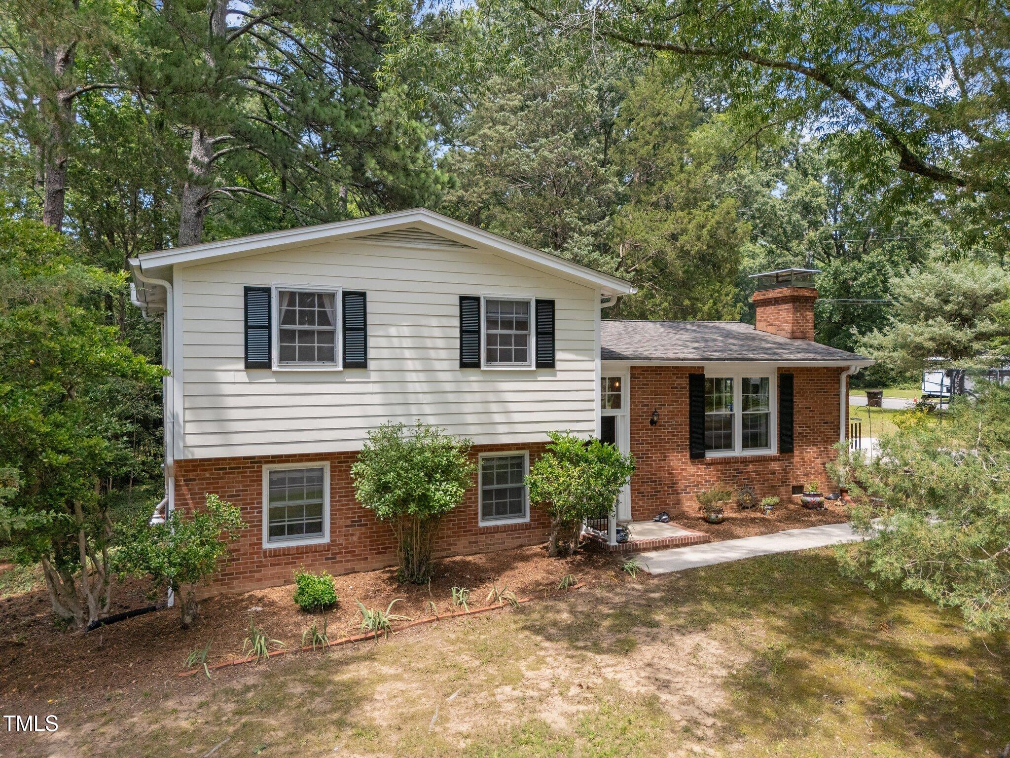 1205 Willow Drive Chapel Hill, NC 27517 - Photo 32 of 45 a front view of house with yard and trees in the background