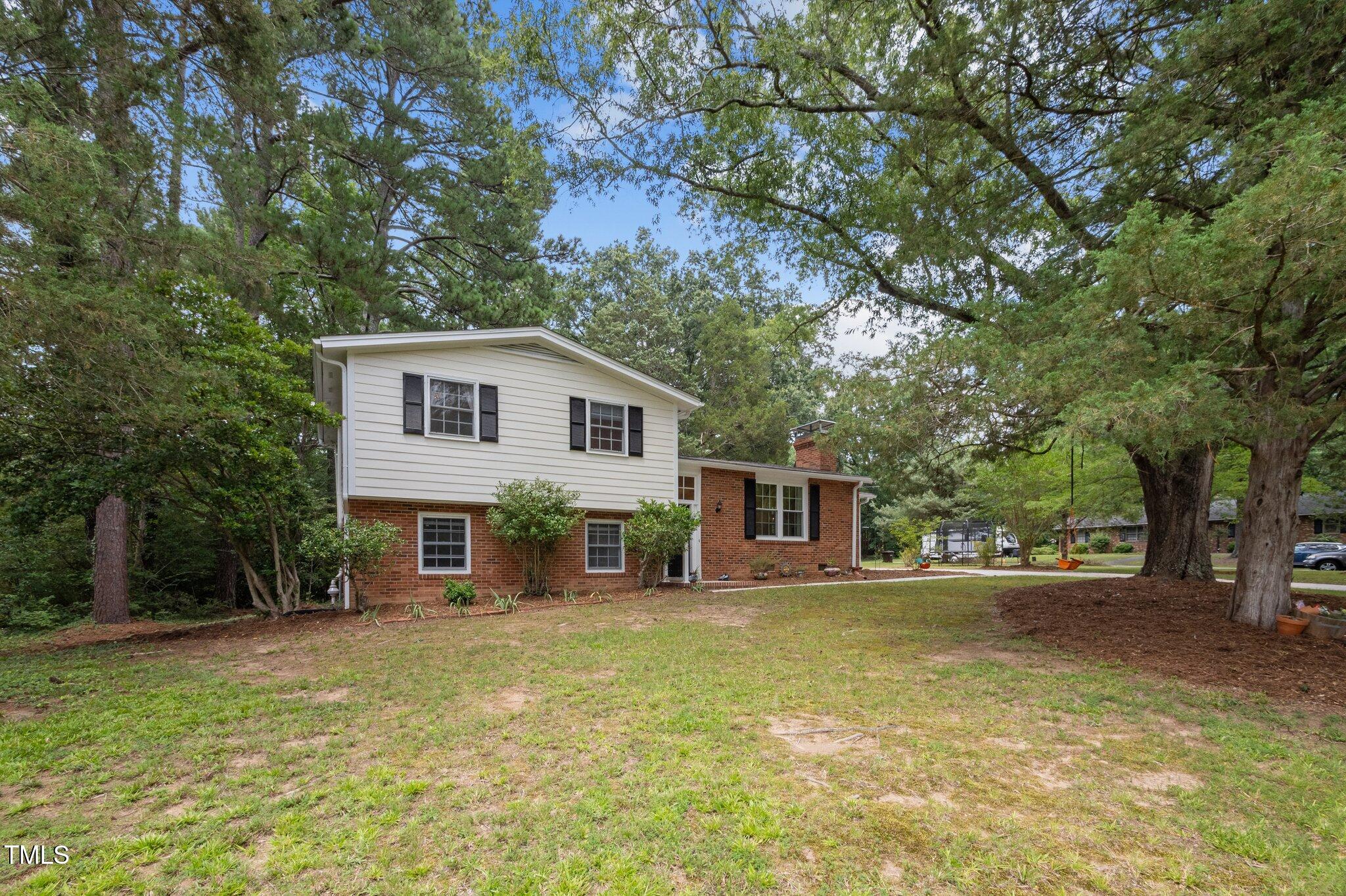 1205 Willow Drive Chapel Hill, NC 27517 - Photo 33 of 45 a view of a house with a backyard and a tree