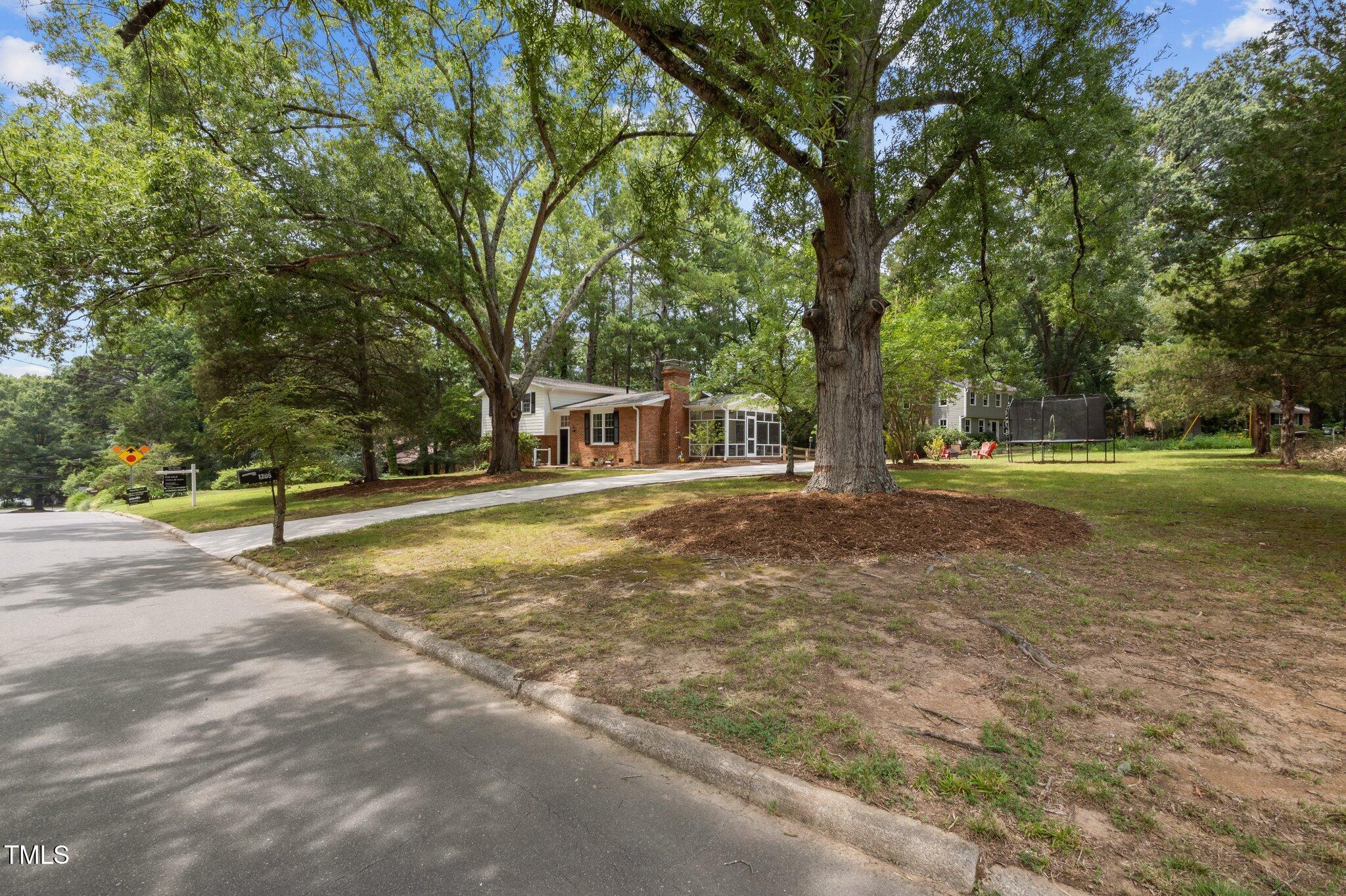 1205 Willow Drive Chapel Hill, NC 27517 - Photo 41 of 45 a view of a house with a big yard and large trees