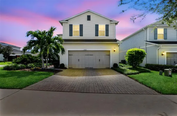 a aerial view of a house with a yard and potted plants