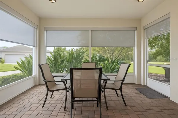 a living room with furniture kitchen view and a flat screen tv