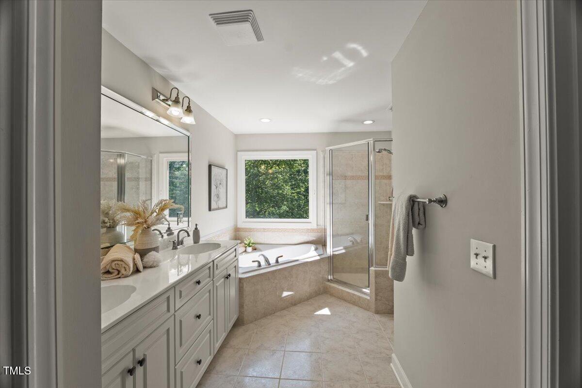 1404 Kings Lassiter Way Raleigh, NC 27614 - Photo 17 of 28 a bathroom with a double vanity sink toilet and shower