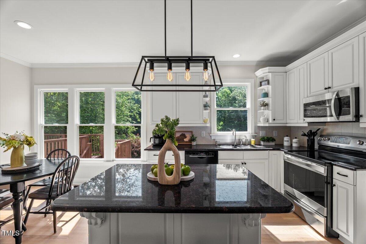1404 Kings Lassiter Way Raleigh, NC 27614 - Photo 2 of 28 a kitchen with sink stove and cabinets