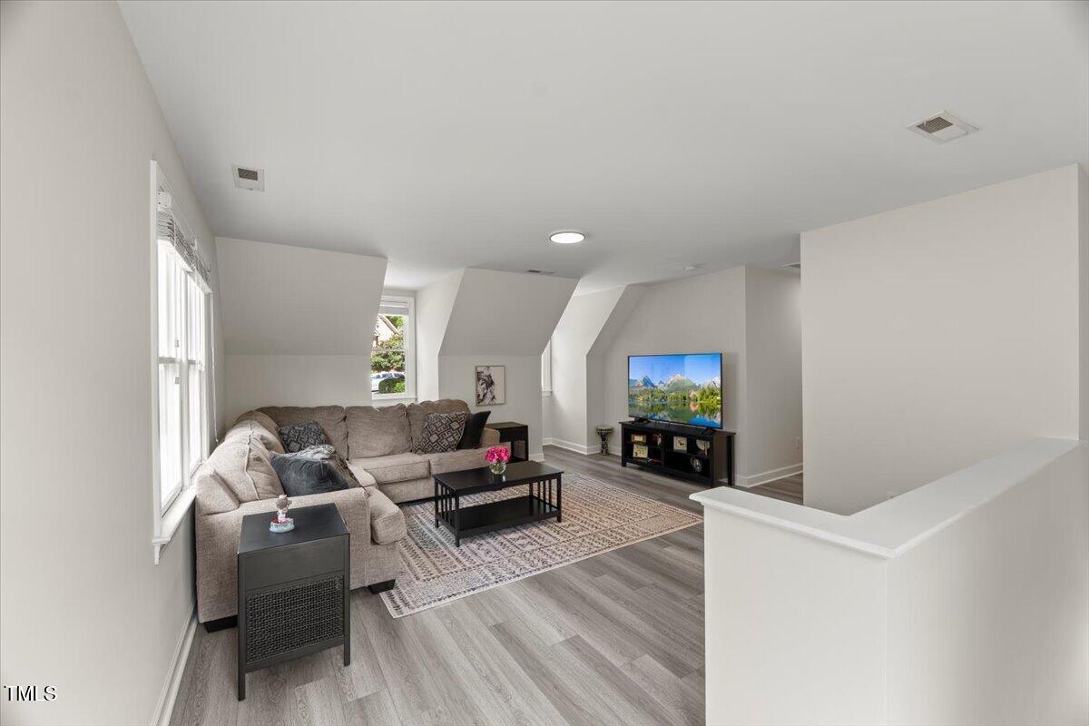 1404 Kings Lassiter Way Raleigh, NC 27614 - Photo 21 of 28 a living room with furniture and a flat screen tv