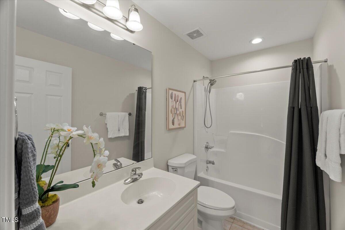 1404 Kings Lassiter Way Raleigh, NC 27614 - Photo 24 of 28 a bathroom with a sink toilet and shower