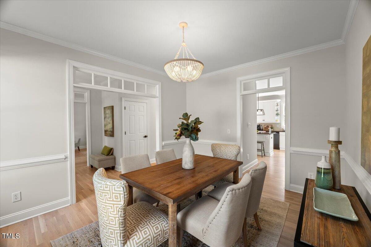 1404 Kings Lassiter Way Raleigh, NC 27614 - Photo 3 of 28 a dining room with furniture and wooden floor