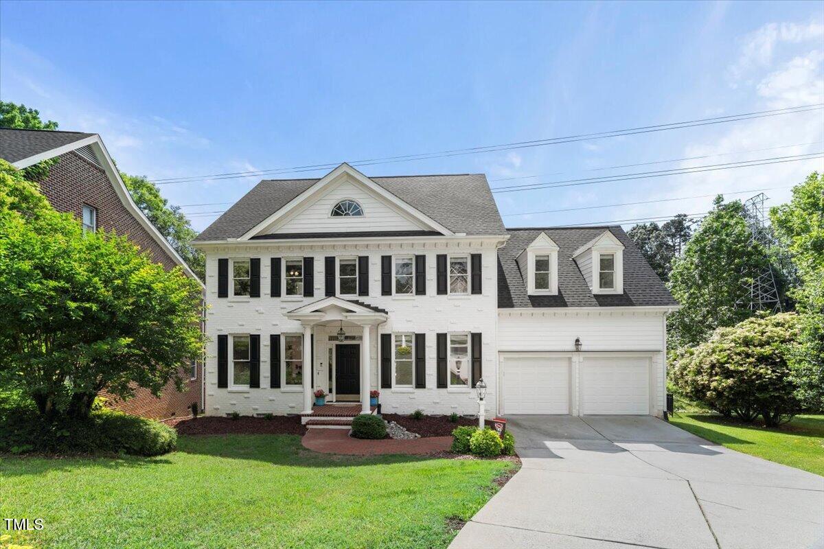 1404 Kings Lassiter Way Raleigh, NC 27614 - Photo 4 of 28 a front view of a house with a yard table and chairs