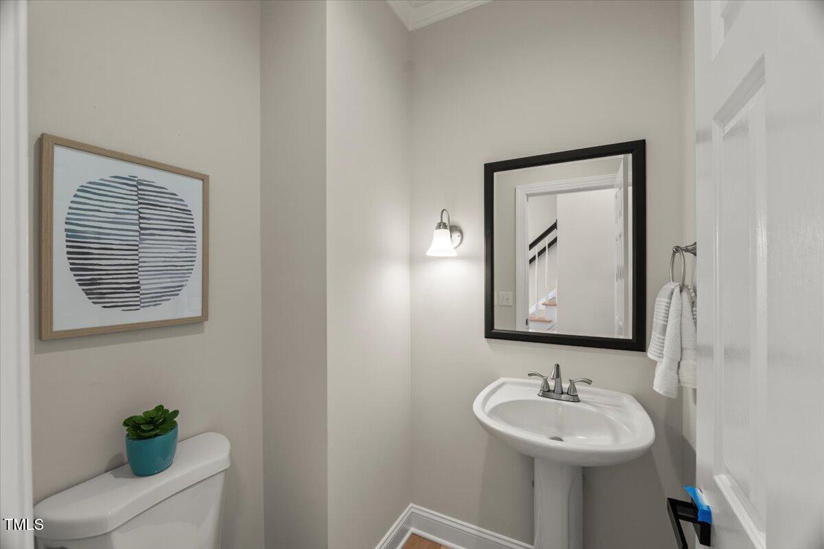 1404 Kings Lassiter Way Raleigh, NC 27614 - Photo 9 of 28 a bathroom with a toilet sink and mirror