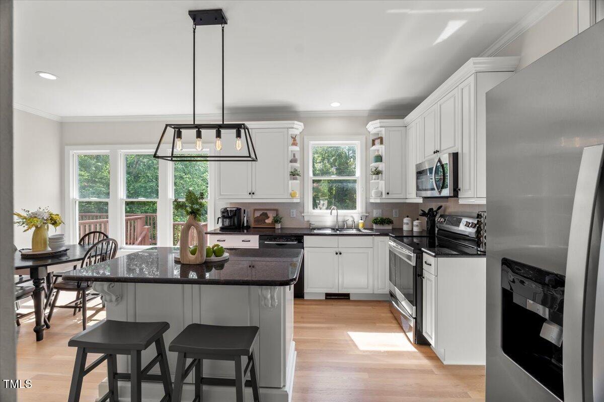 1404 Kings Lassiter Way Raleigh, NC 27614 - Photo 10 of 28 a kitchen with stainless steel appliances granite countertop a stove top oven a sink a stove and a refrigerator