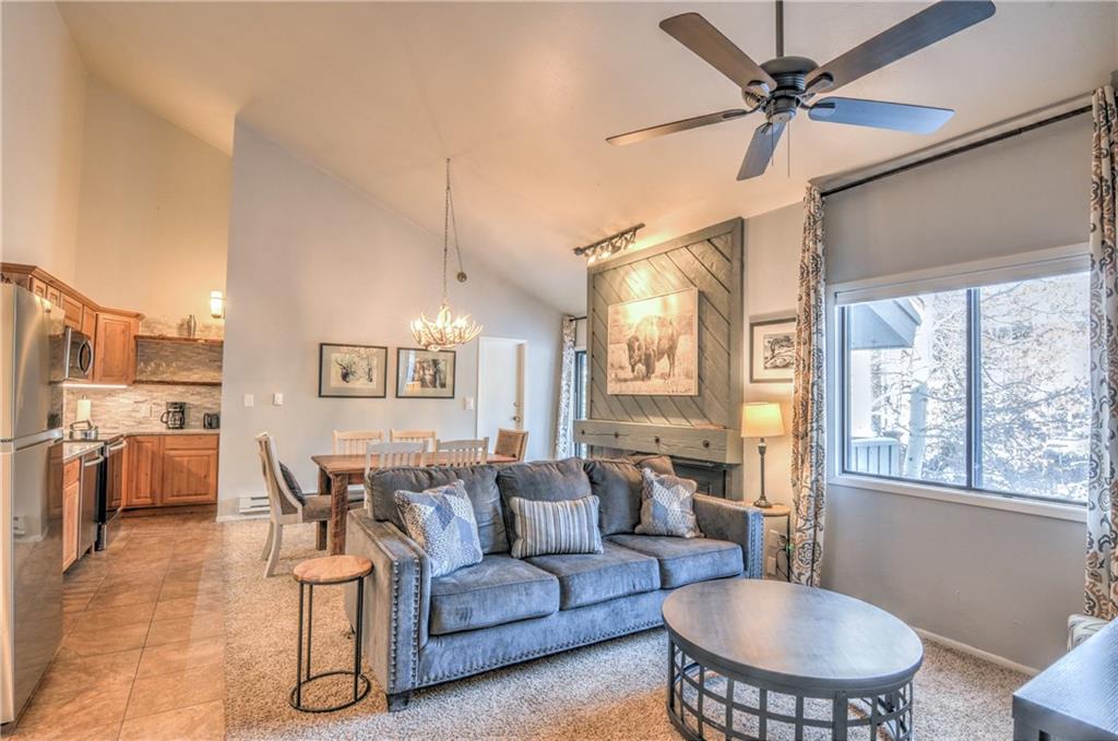 1977 Soda Ridge Road, Unit 1218 Keystone, CO 80435 - Photo 1 of 23 a living room with furniture a fireplace and a chandelier