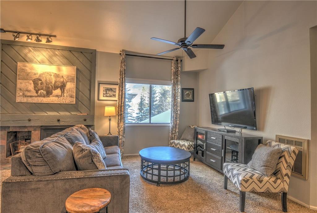 1977 Soda Ridge Road, Unit 1218 Keystone, CO 80435 - Photo 2 of 23 a living room with furniture a flat screen tv and a window