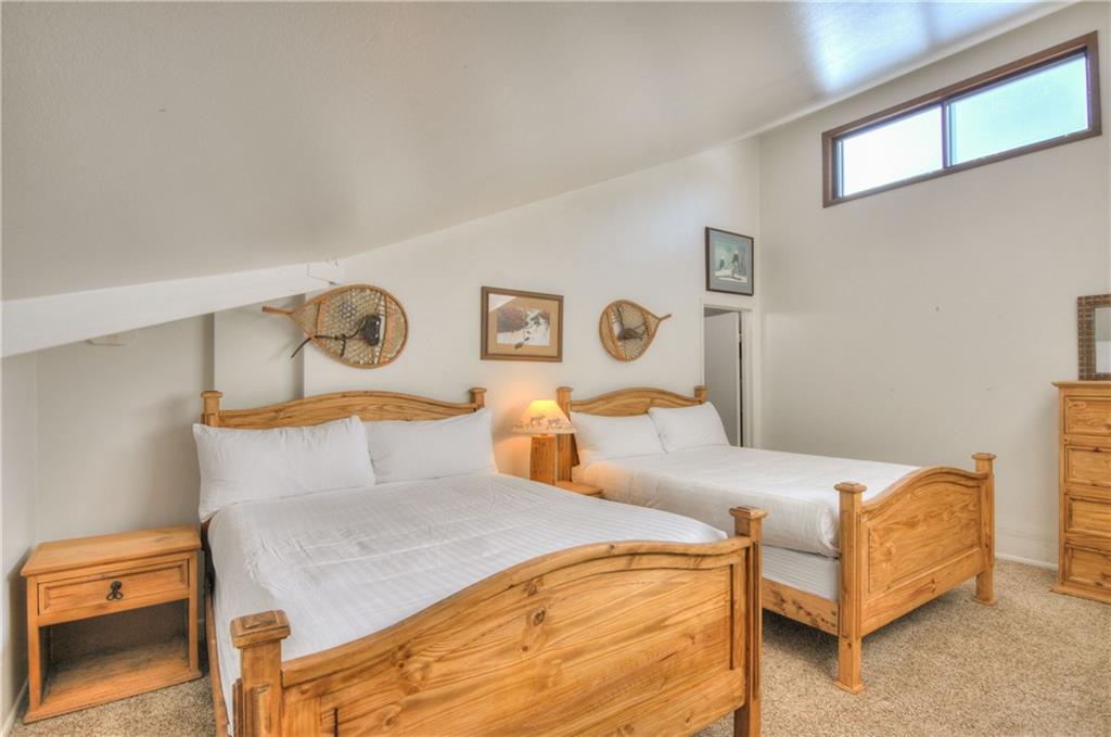 1977 Soda Ridge Road, Unit 1218 Keystone, CO 80435 - Photo 12 of 23 a bedroom with a bed and window