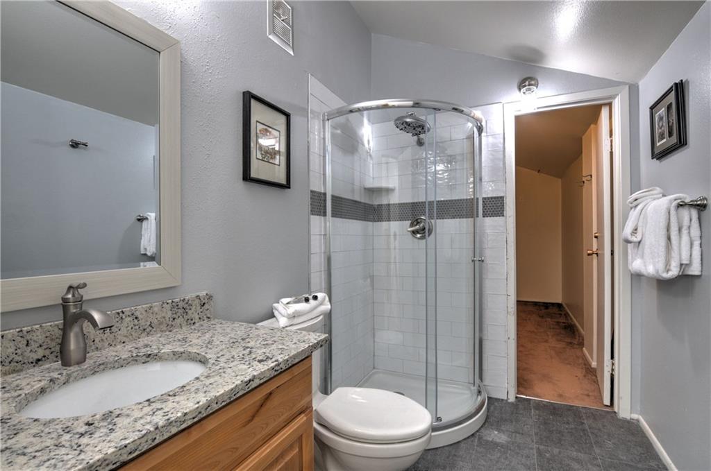 1977 Soda Ridge Road, Unit 1218 Keystone, CO 80435 - Photo 14 of 23 a bathroom with a granite countertop sink toilet and shower