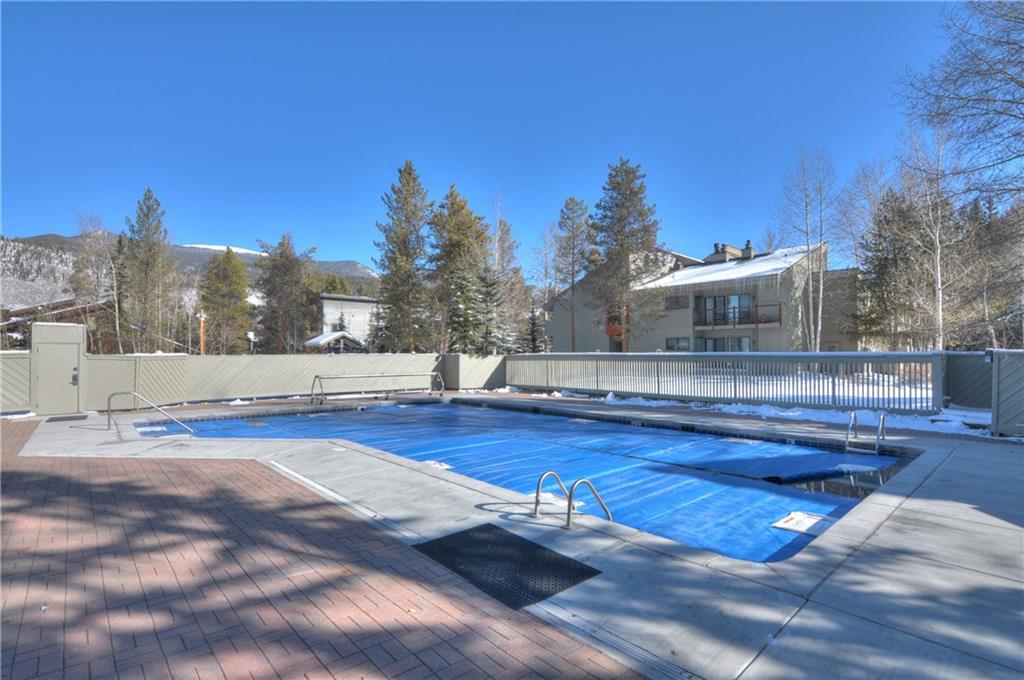 1977 Soda Ridge Road, Unit 1218 Keystone, CO 80435 - Photo 21 of 23 a view of swimming pool with seating area and trees in the background