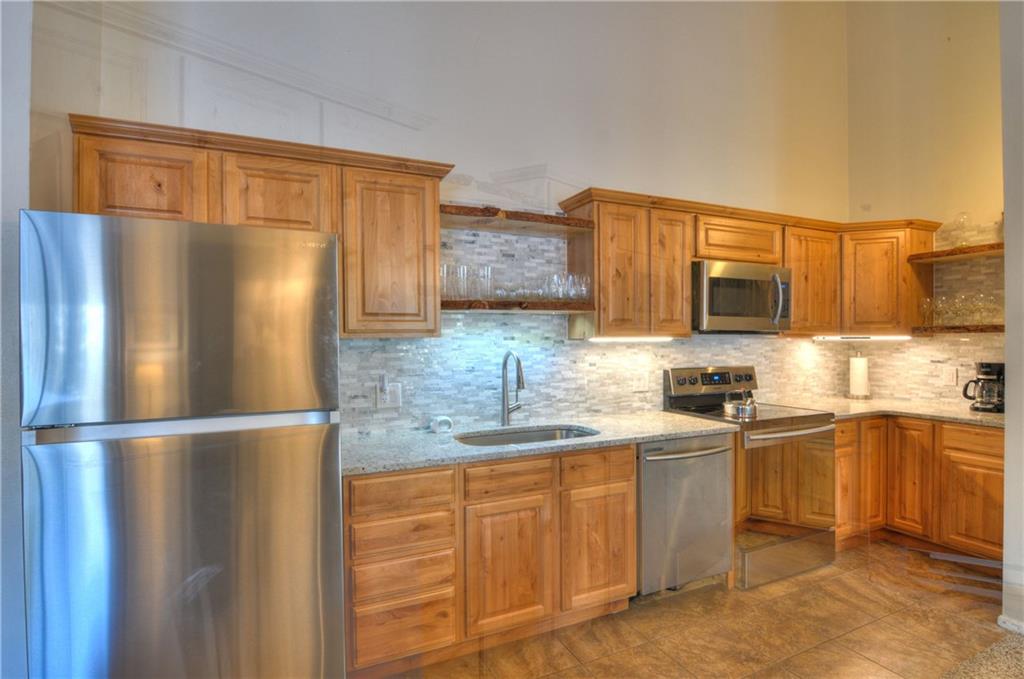 1977 Soda Ridge Road, Unit 1218 Keystone, CO 80435 - Photo 6 of 23 a kitchen with stainless steel appliances granite countertop a refrigerator sink and cabinets