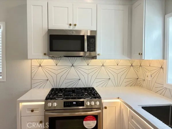 a stove top oven sitting inside of a kitchen