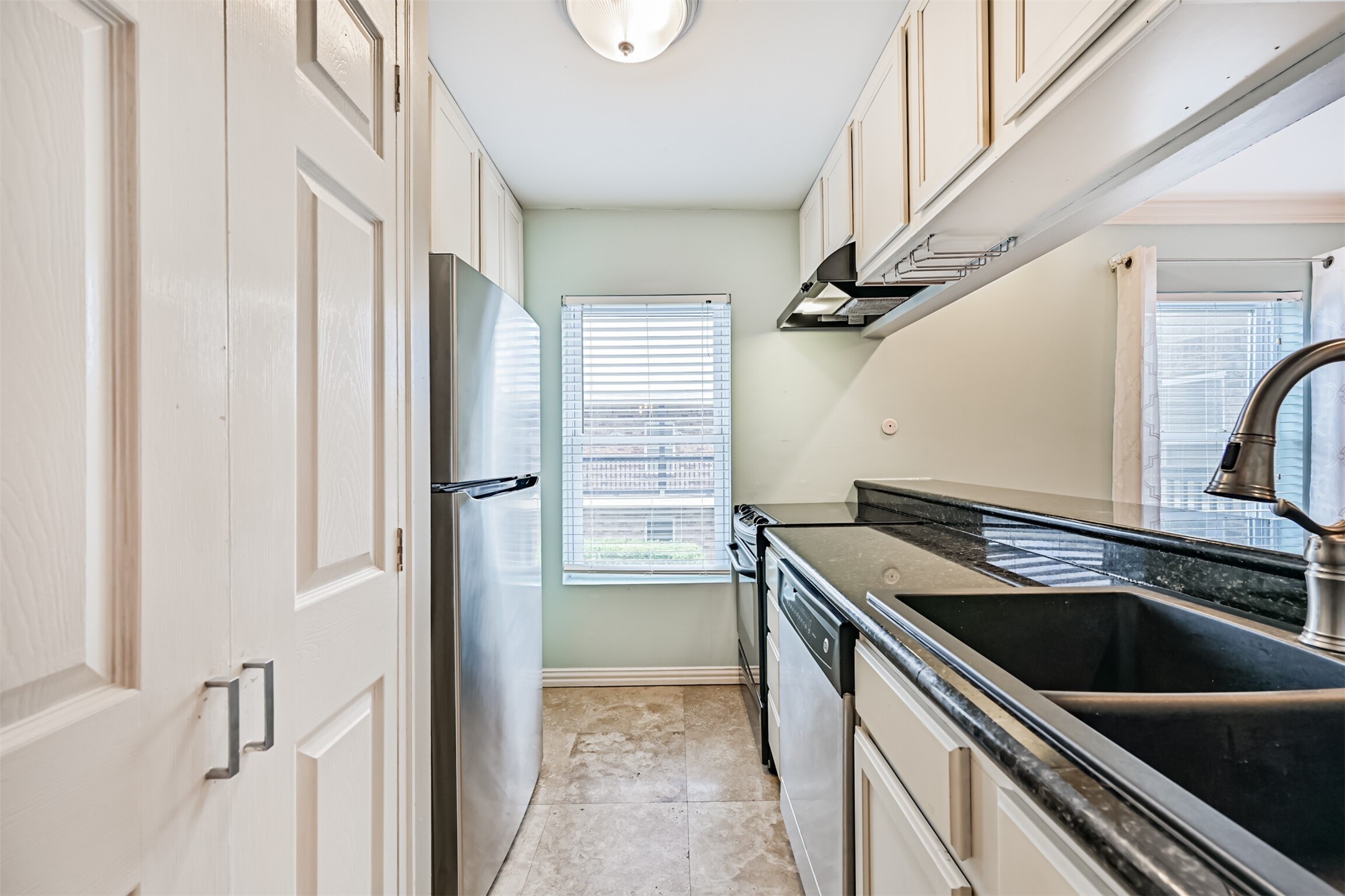402 Postoffice Street, Unit 201 Galveston, TX 77550 - Photo 11 of 29 a view of a kitchen with a sink and dishwasher