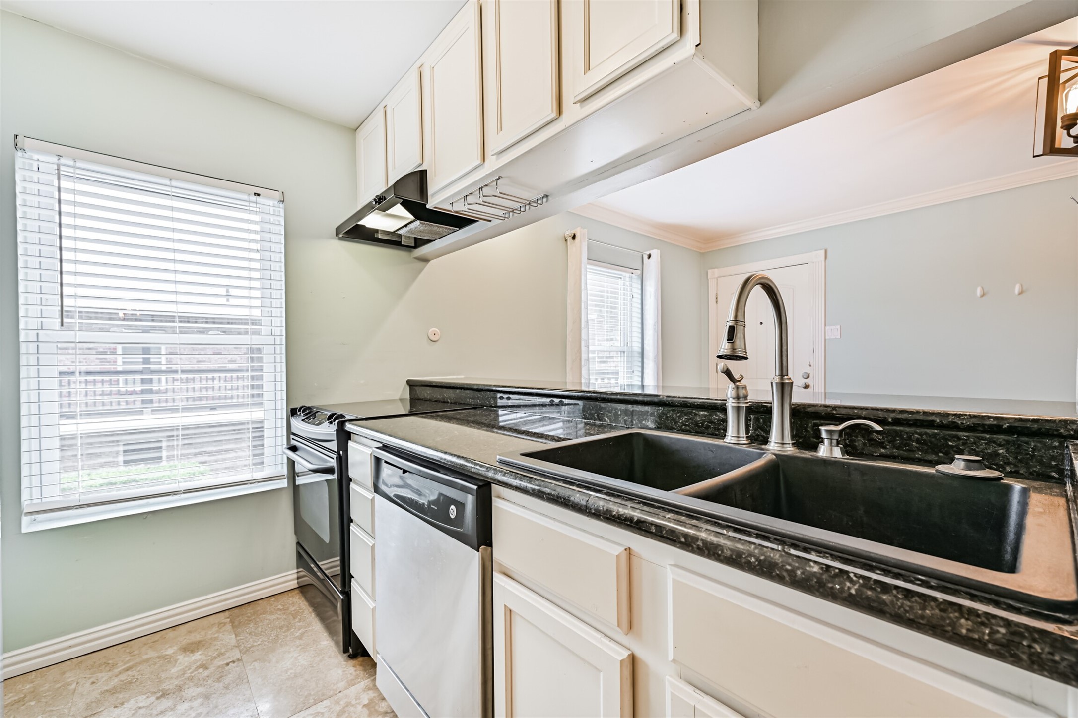 402 Postoffice Street, Unit 201 Galveston, TX 77550 - Photo 14 of 29 a kitchen with stainless steel appliances granite countertop a sink and cabinets