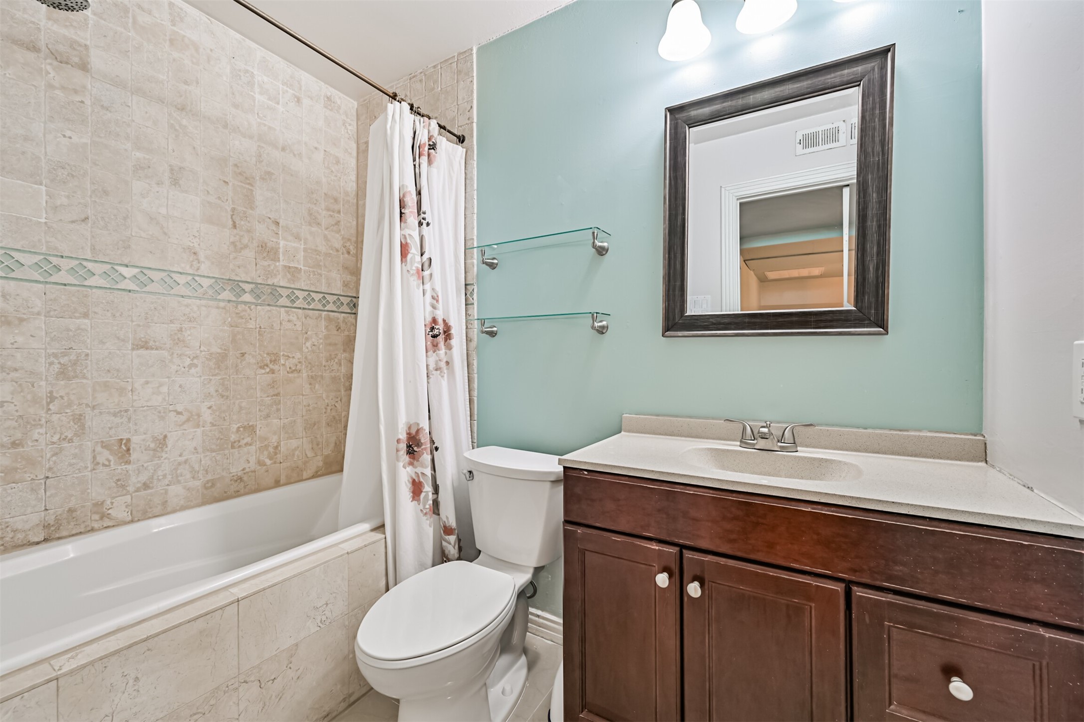 402 Postoffice Street, Unit 201 Galveston, TX 77550 - Photo 22 of 29 a bathroom with a sink a toilet and shower