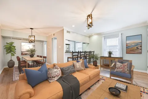 a living room with furniture and a glass door
