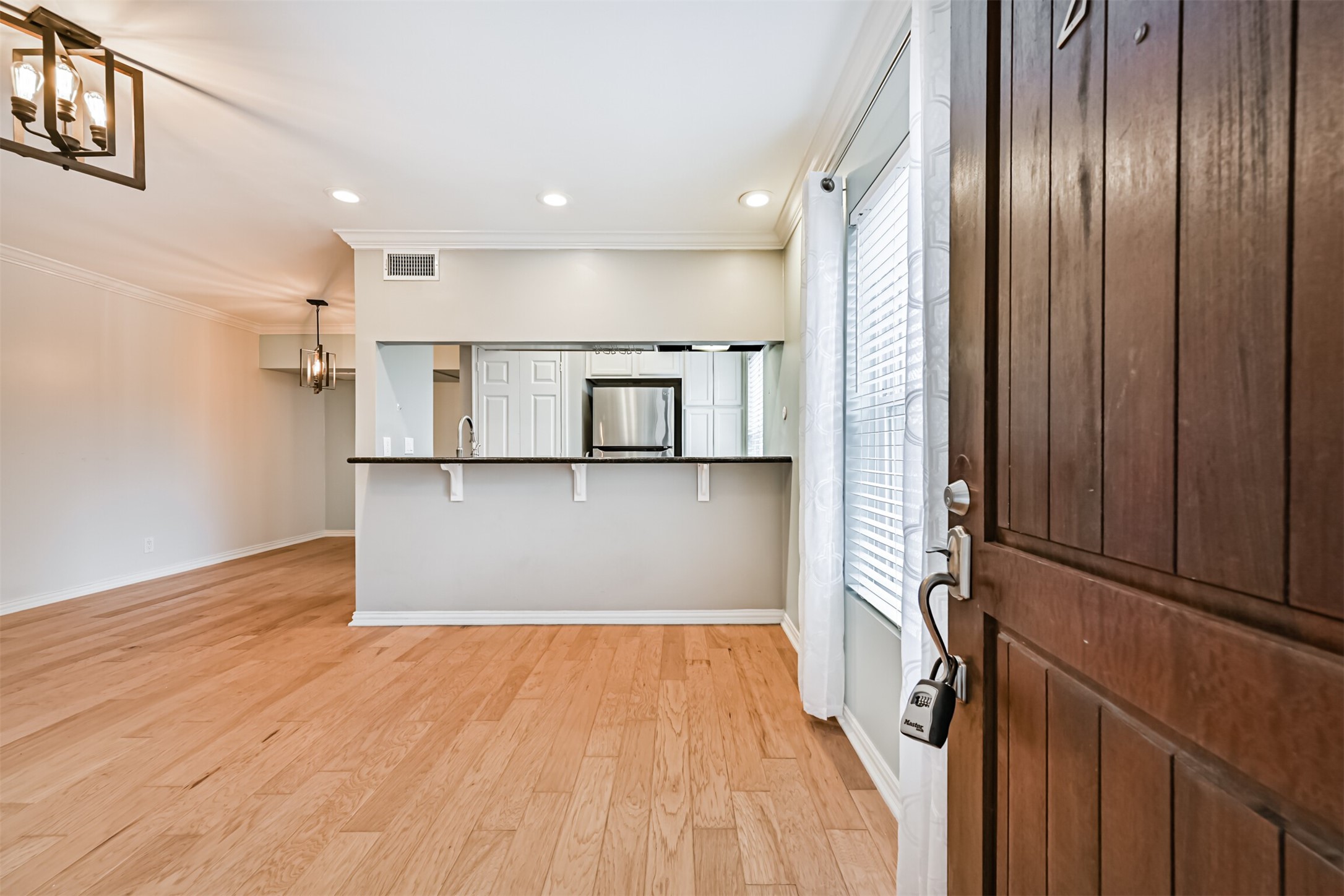 402 Postoffice Street, Unit 201 Galveston, TX 77550 - Photo 5 of 29 a view of a kitchen with wooden floor and electronic appliances