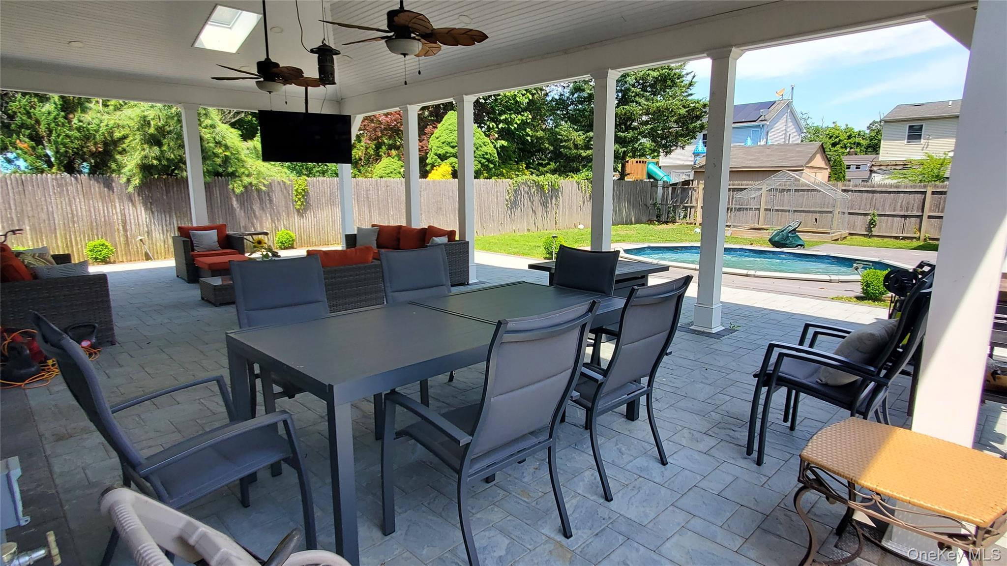 29 Oak Street Islip, NY 11751 - Photo 13 of 15 Fenced backyard with a patio, a ceiling fan, outdoor dining space, and outdoor lounge area