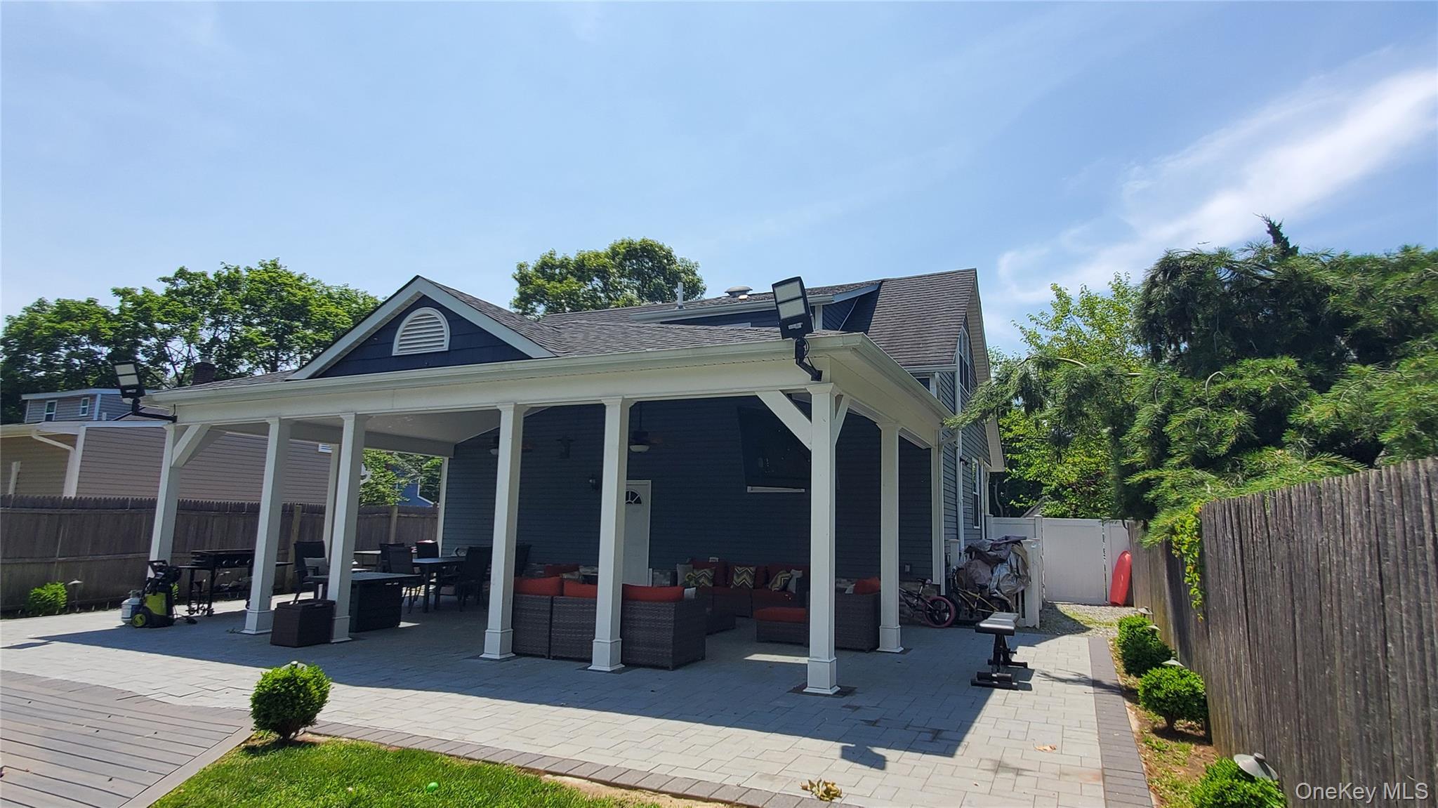 29 Oak Street Islip, NY 11751 - Photo 15 of 15 Back of property with a fenced backyard, an outdoor hangout area, a patio area, a shingled roof, and outdoor dining area
