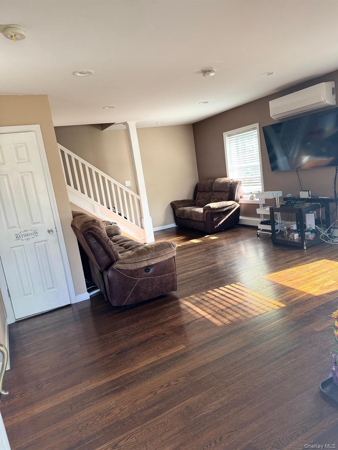 29 Oak Street Islip, NY 11751 - Photo 2 of 15 Living room featuring dark wood-style flooring, an AC wall unit, stairway, and recessed lighting