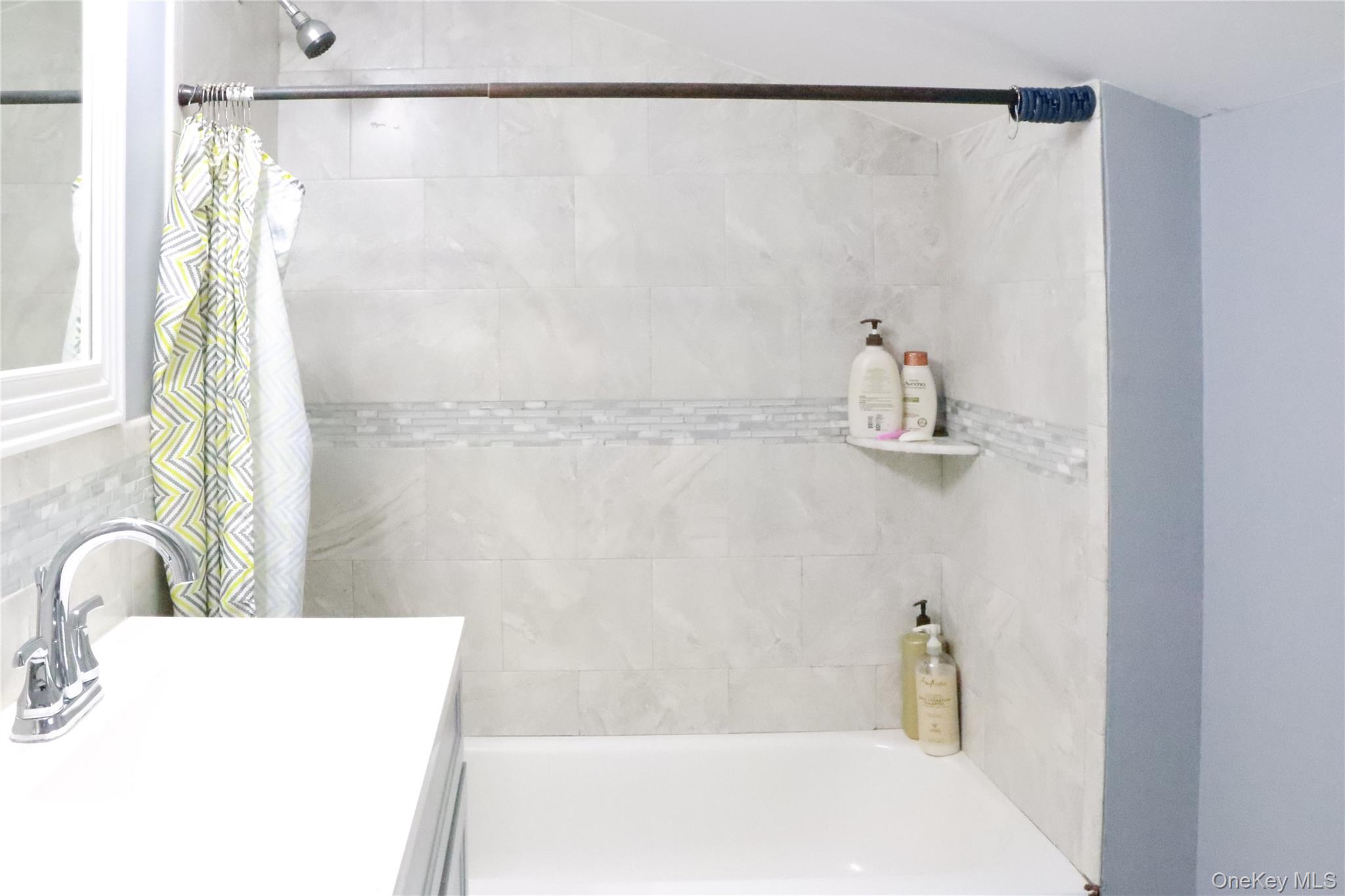 29 Oak Street Islip, NY 11751 - Photo 10 of 15 Bathroom featuring shower / bathtub combination with curtain and vanity