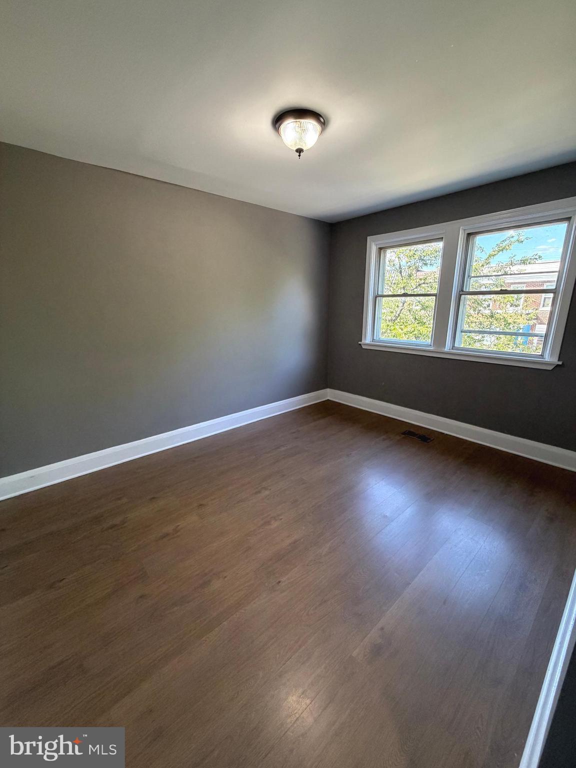 1353 Cambria Street Baltimore, MD 21225 - Photo 10 of 23 an empty room with a window