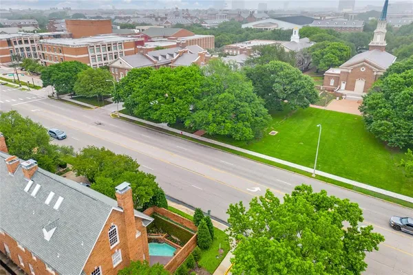 an aerial view of a house with a garden and trees