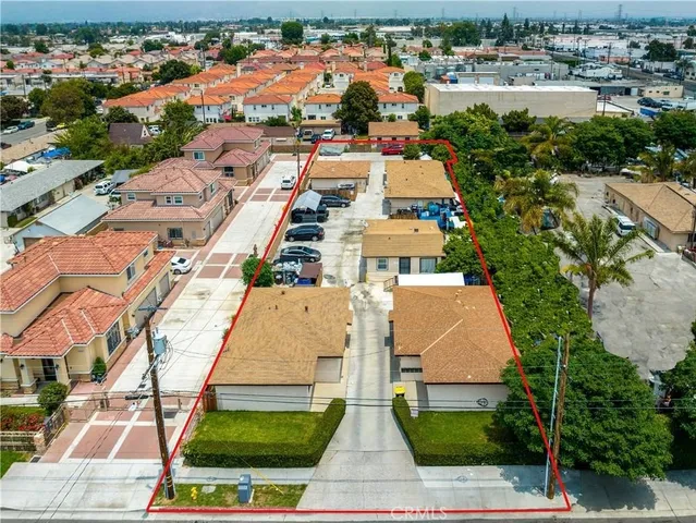 an aerial view of residential houses with outdoor space