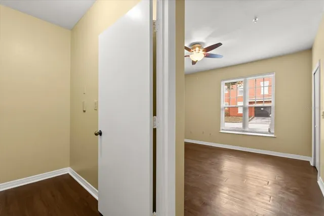 wooden floor in an empty room with a window