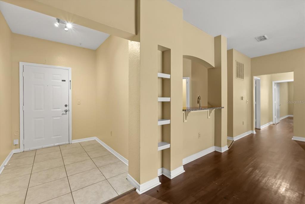 126 Vista Verdi Circle, Unit 108 Lake Mary, FL 32746 - Photo 4 of 20 a view of a hallway with wooden floor and a bathroom