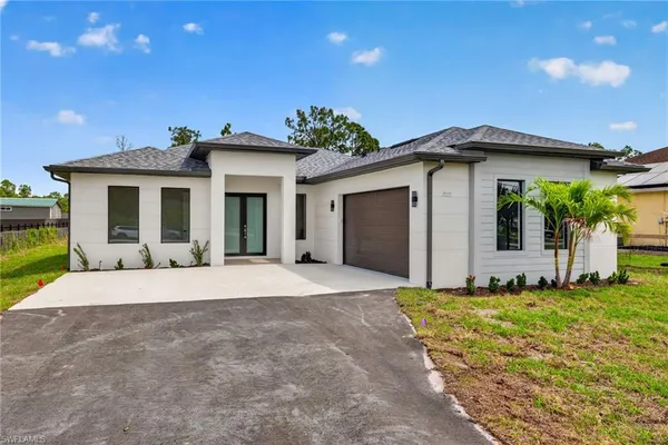 a front view of a house with a yard