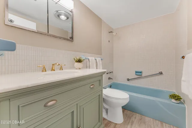 a bathroom with a sink a toilet and a shower