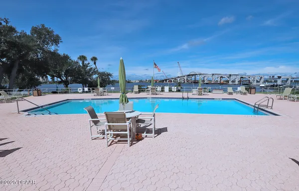 a swimming pool with outdoor seating and yard
