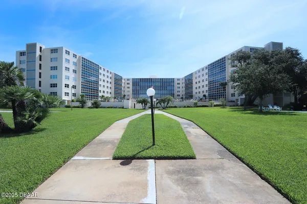 a view of a building with a yard