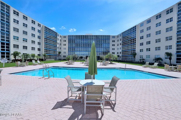 a view of swimming pool with outdoor seating